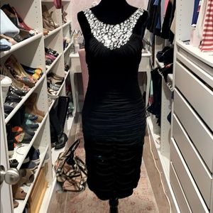 Black knee length cocktail dress. Beaded neck